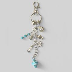 a key chain with charms and beads hanging from it