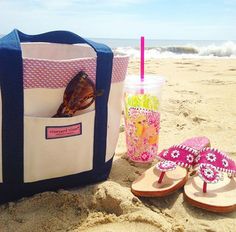 a beach bag and flip flops on the sand