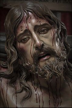 a statue of jesus with blood dripping down his face