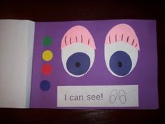 an open book with the words i can see and two large eyes on purple paper