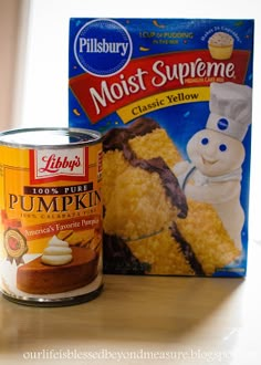 a can of cake next to a box of frosting