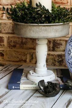 a blue and white plate sitting on top of a wooden table next to a candle