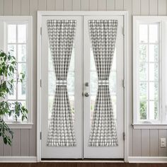 the front door is decorated with plaid curtains