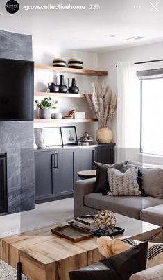 a living room filled with furniture and a flat screen tv mounted on the wall next to a fire place