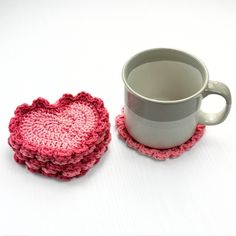 two crocheted coasters next to a coffee cup