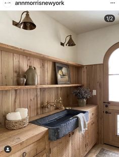 a kitchen with wood paneling and an antique sink