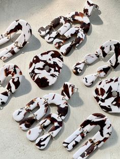 several pieces of animal print jewelry laid out on the ground