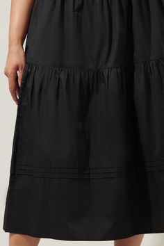 The perfect closet staple has arrived. A classic, cotton midi skirt that features an elastic waist for comfort tops an A line silhouette. Tiers break the skirt up, along with pleats that wrap around the lower tier. Pair it with a ribbed tank or an eyelet cami for the ultimate summer look.- Breathable- Pockets- A line- Pleats- Comes in 4 colorsSize + Fit - Model is 5'8" and wearing size 2X- Measurements taken from size 2X - Waist: 19 1/4"- Length: 34" Fabric self: 100%cotton Style Number STS7022X Relaxed Fit Tiered Maxi Skirt With Elastic Waistband, Pleated Flared Skirt Midi Dress, Summer Midi Dress With Ruffled Skirt, Cotton Midi Dress For Day Out, Flowy Midi Dress With Gathered Skirt, Modest Tiered Skirt With Elastic Waistband, Solid Color Tiered Skirt With Pleated Waist, Relaxed Fit Tiered Maxi Skirt With Lining, Pleated Tiered Maxi Skirt For Day Out