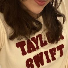 a close up of a person wearing a shirt with the words taylor swift on it