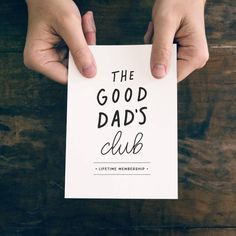 two hands holding a card that says the good dad's club