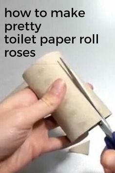 someone is holding a roll of toilet paper and cutting it