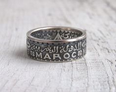 Ring made from coin 200 francs 1953 Morocco.(According to Muslim chronology, 1953 is 1372.) Metal - silver 720 I can make sizes  6 - 10 US Width - approximately 7.5-8 millimeters. I need 2-4 business days to make ring. If you have any questions - please write to me) Vintage Coin-shape Engraved Ring For Anniversary, Vintage Coin-shaped Engraved Anniversary Ring, Vintage Coin Engraved Anniversary Ring, Vintage Engraved Ring For Commemoration, Vintage Engraved Commemorative Ring, Vintage Engraved Commemoration Ring, Silver Coin Ring, Moroccan Jewelry, Coin Ring