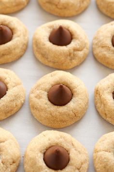 chocolate chip cookies are arranged in rows on a baking sheet, ready to be eaten