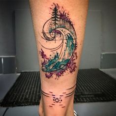 a tattoo on the leg of a person with watercolor splashes and pine trees