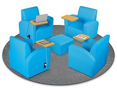 blue chairs and tables are arranged in a circle with a laptop on the table top