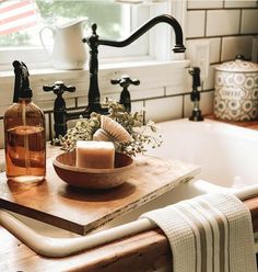 a wooden cutting board sitting on top of a kitchen counter next to a sink and faucet