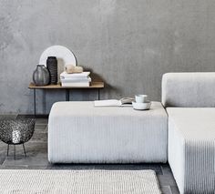 a white couch sitting next to a wooden table