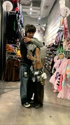 two people standing in a store hugging each other