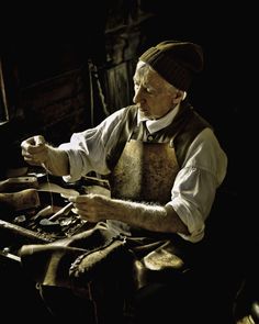 an old man is working on something in his workshop