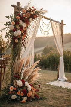 an outdoor wedding setup with flowers and greenery