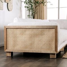 a white couch sitting on top of a hard wood floor