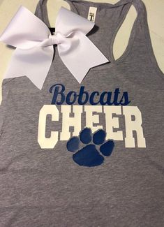 a gray tank top with a blue and white paw print on the front that says bobcats cheer