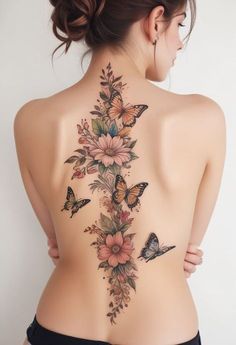 a woman's back with butterflies and flowers on it