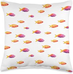 a white pillow with yellow and pink fish pattern on it's front, sitting in front of a white background