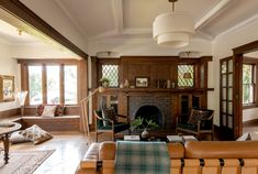 a living room filled with furniture and a fire place in the middle of a room