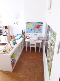 a child's playroom with toys and books on the shelves, including a map