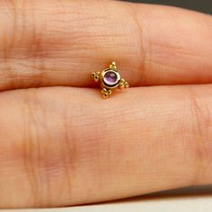 This Mini Kandy piercing you are currently reviewing is handmade. All components are crafted using 14-karat gold. The stone is Natural Amethyst and its in cabochon cut style. I'm able to change and replace the stone with precious stones (diamond, sapphire, ruby, and emerald) or semi-precious stones such as London Topaz, citrine, peridot, tourmaline, tanzanite, amethyst, rhodolite, and more. For further assistance please contact us via Etsy Message. PRODUCT DETAILS: Material: 14K Yellow Gold, 14K Rose Gold Bar Thickness: 18 gauge / 1 mm Bar Length Options: 6 or 8 mm Closure: Internally Threaded Screw Flat Back Piercing Pin Dimensions: 5.5 mm Areas of Use: This screw flat back piercing is suitable for use on the cartilage, earlobe, helix, low helix, tragus, anti-tragus, and conch areas. With Gold Gemstone Piercings As A Gift, Gold Gemstone Piercings For Gifts, Anti Tragus, Stud Piercing, Earring Cartilage, Rose Gold Bar, Tragus Earring, Piercing Cartilage, Helix Earring