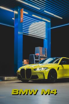 a yellow sports car parked in front of a gas station with the words bmw m4