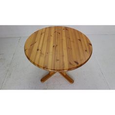 a wooden table sitting on top of a white floor