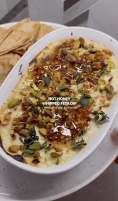 a white plate topped with food next to tortilla chips