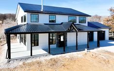 a white house with black roof and windows