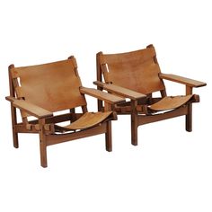 two wooden chairs sitting next to each other