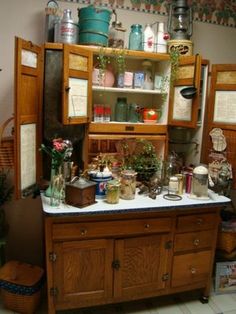 an old fashioned kitchen with lots of pots and pans