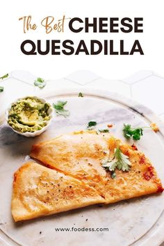 two quesadillas on a plate with guacamole