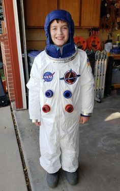 a young boy dressed in an astronaut suit