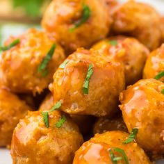 some meatballs are piled on top of each other and garnished with parsley