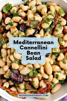 a white bowl filled with beans and spinach next to a blue sign that says mediterraneanan cannellini bean salad