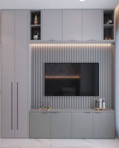 an entertainment center with built in cabinets and a flat screen tv mounted on the wall