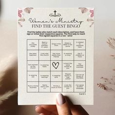 a person holding up a card that says women's charity find the guest bingo