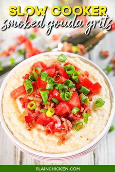 slow cooker smothered goulash grits in a bowl with green onions and tomatoes