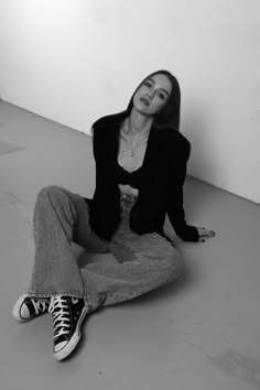 a woman sitting on the floor with her legs crossed