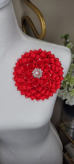 a white mannequin with a red flower on it