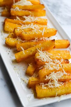 french fries with parmesan cheese on a white plate