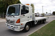 a white truck is parked on the side of the road