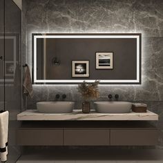 a bathroom with two sinks and a large mirror above the sink in front of it