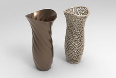 two vases sitting side by side next to each other